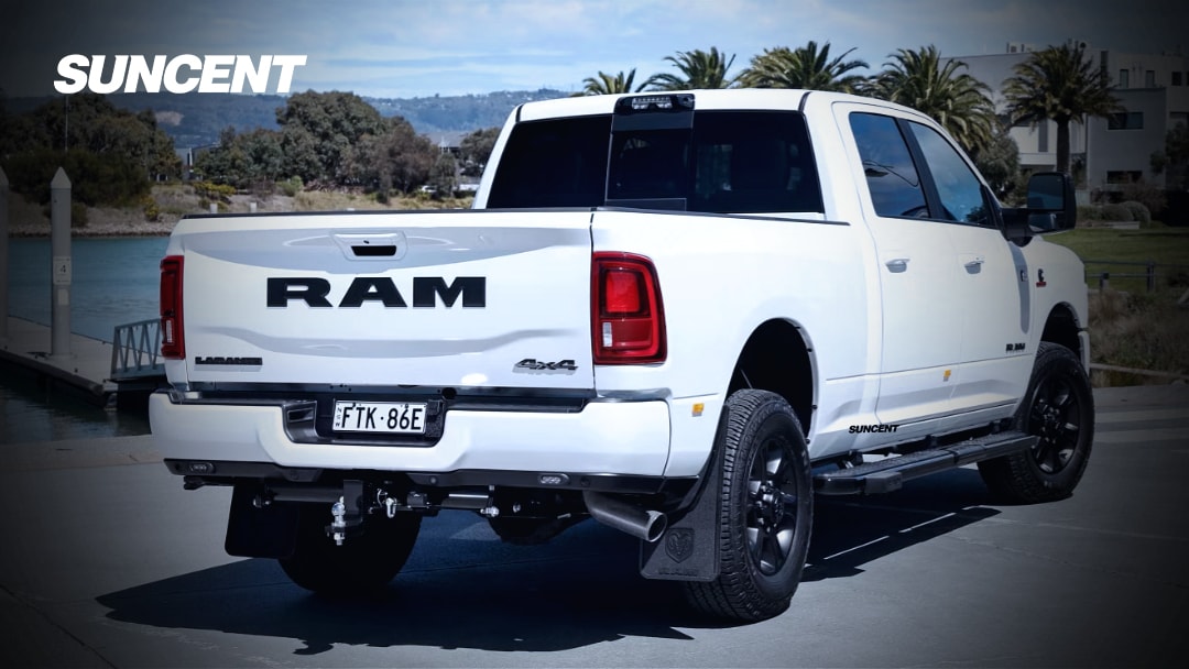 Rear close-up of a RAM 2500 diesel truck showing the polished tip of a 5-inch straight-pipe Turbo-back exhaust system, hinting at the authentic Cummins whistle.