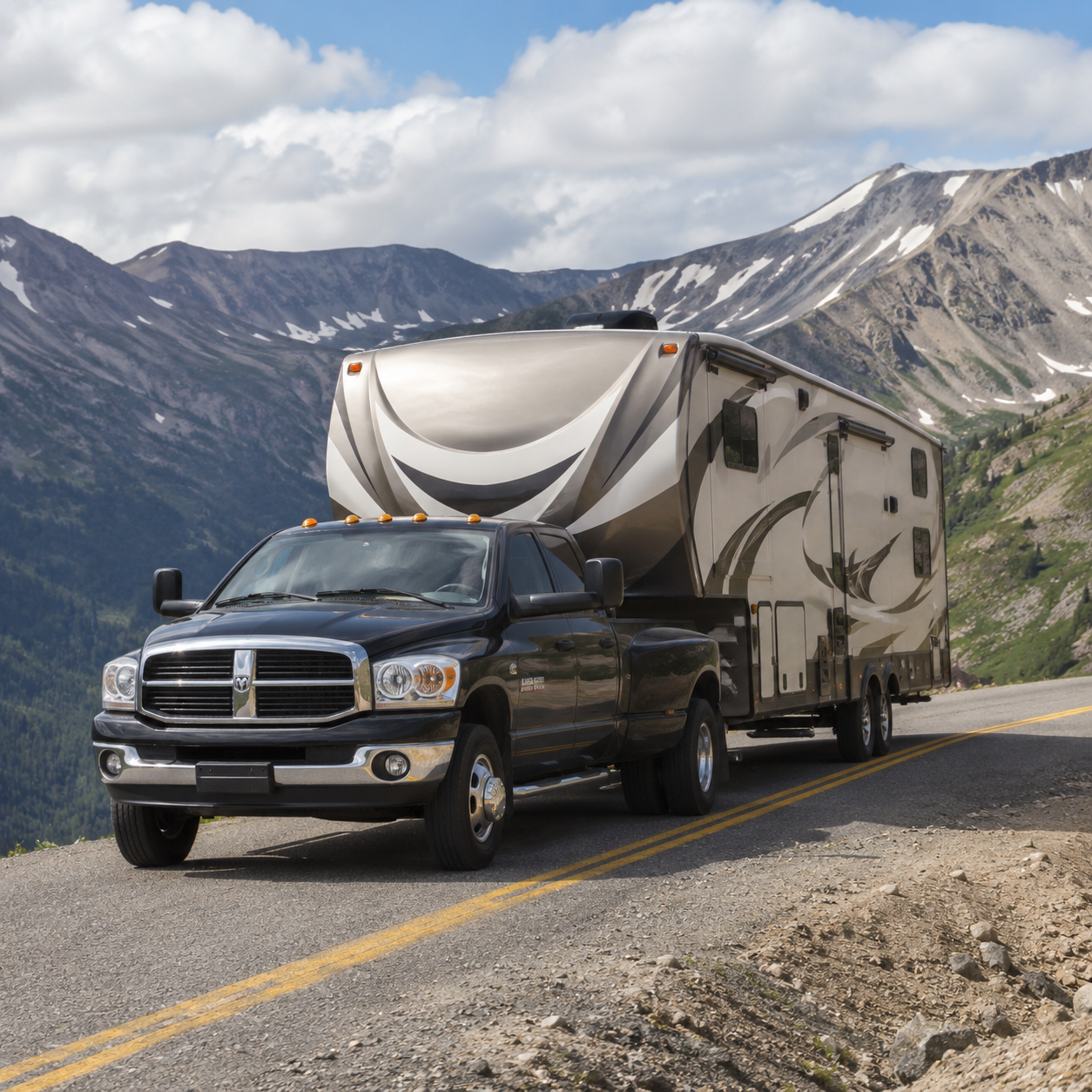 2008 Dodge Ram 2500 towing a large fifth-wheel RV over a mountain pass in the United States